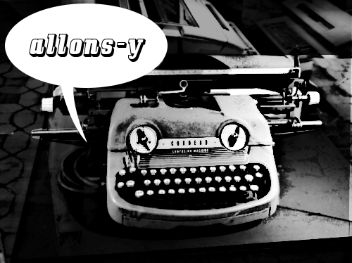 Machine à écrire mécanique évoquant une figure anthropomorphe avec une bulle de BD lui faisant dire "allons-y".